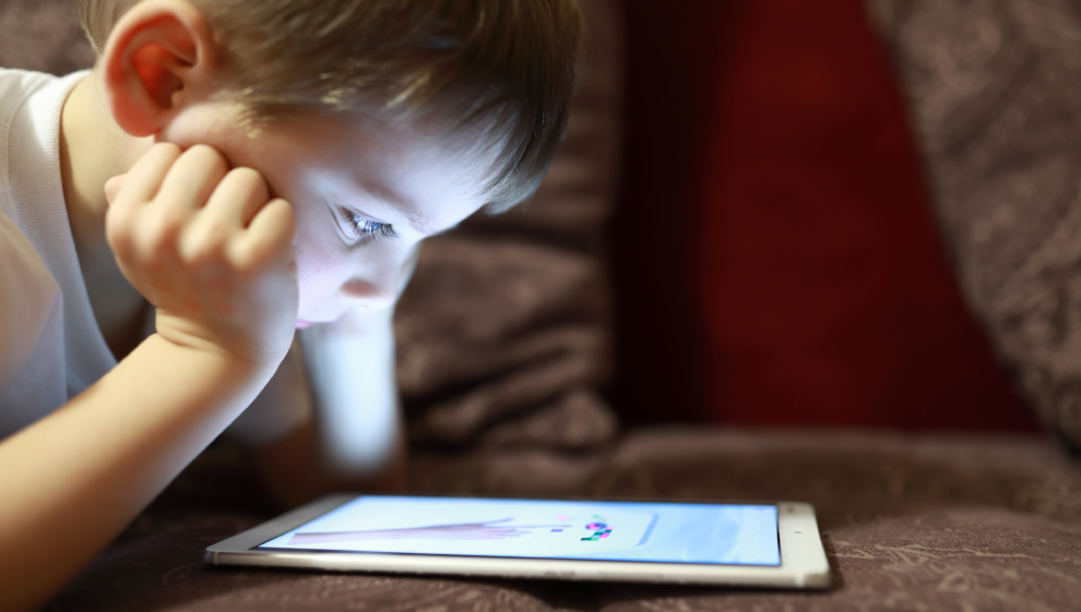 A young child using his tablet