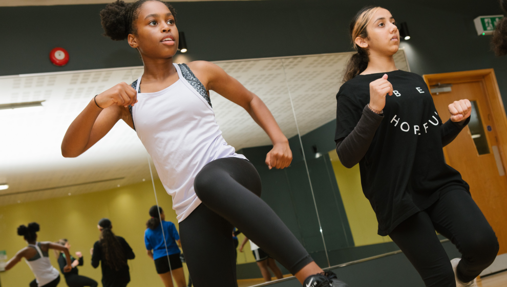 Two girls exercising in a fitness class
