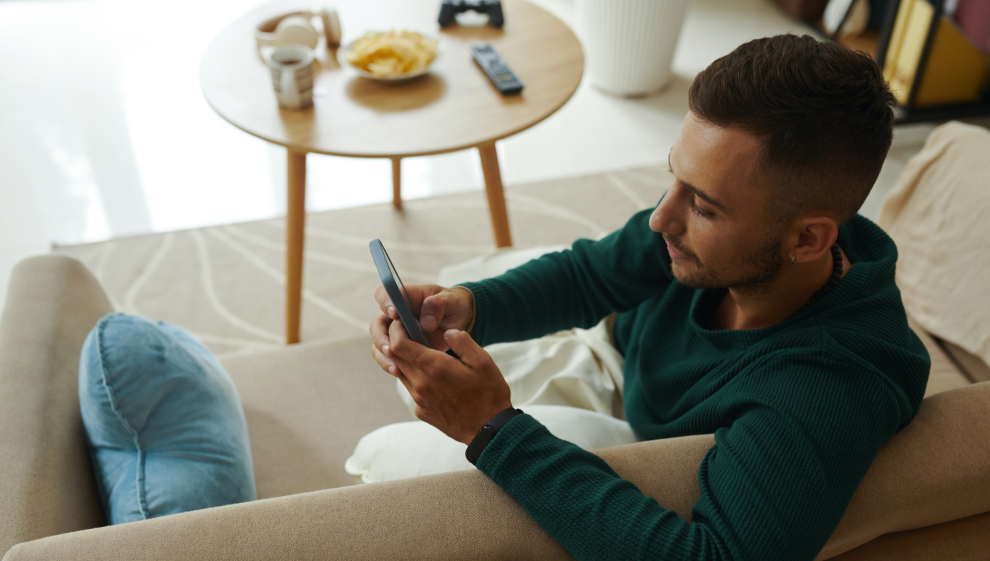 Man on sofa using smartphone